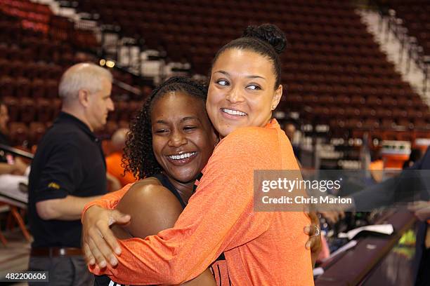 Tamika Catchings of the Eastern Conference All Stars and Kayla McBride of the Western Conference All Stars pose for a photo during the Boost Mobile...