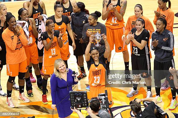 Maya Moore of the Western Conference All Stars holds up the MVP trophy after defeating the Eastern Conference All Stars during the Boost Mobile WNBA...