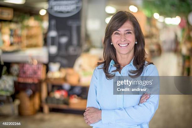 woman at a food market grocery shopping - store manager stock pictures, royalty-free photos & images