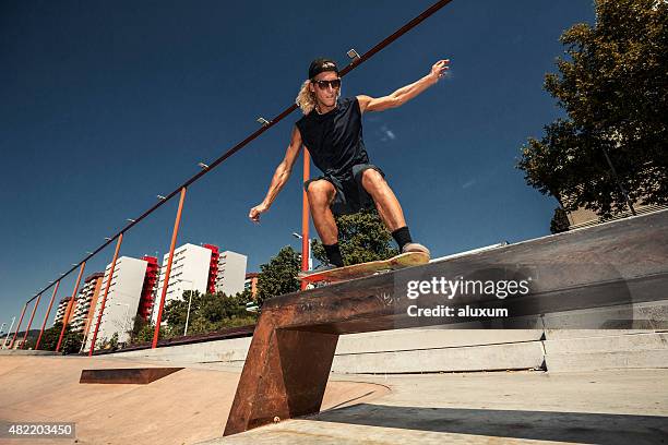 young skateboarder grinding - rail grinding stock pictures, royalty-free photos & images