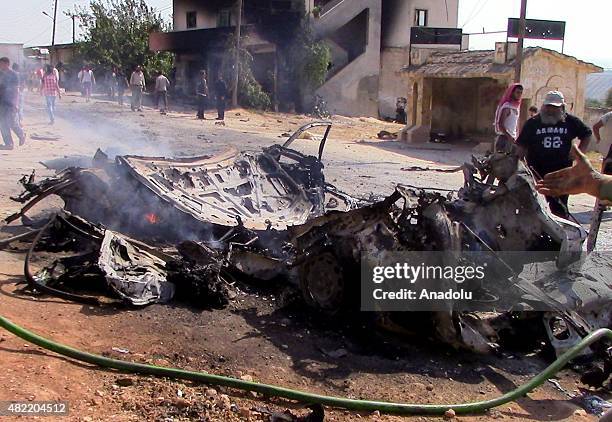 Smoke rises from a wreckage of a wehicle after being hit by US-led coalition forces airstrike targeting Al Nusra members in Kafer Hend village of...