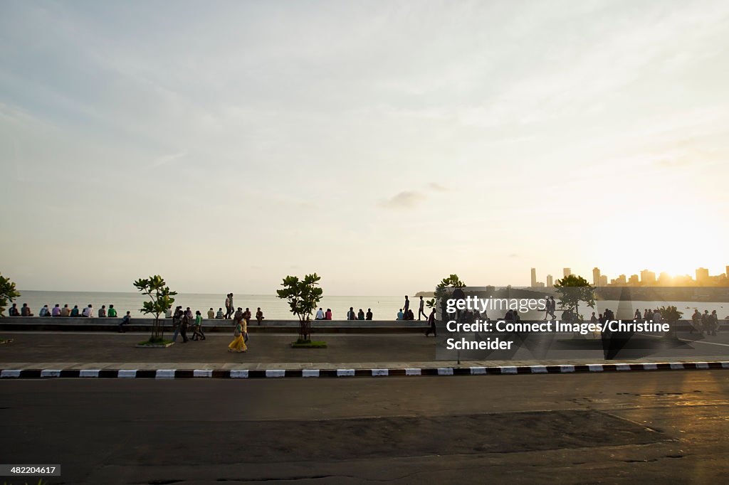 Large group of people strolling on waterfront, Mumbai, India