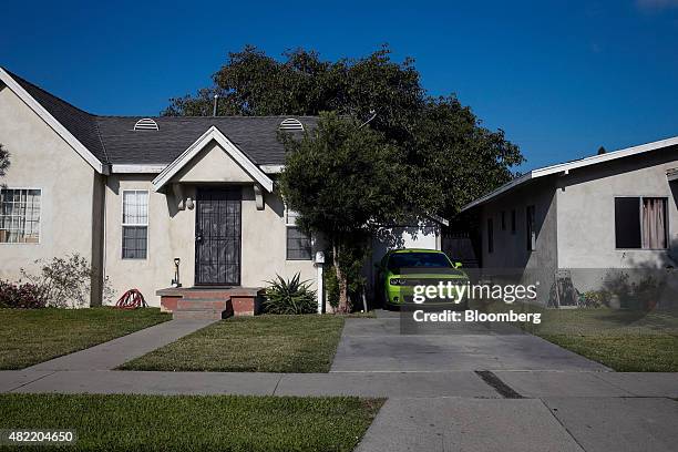 Chrysler Group LLC Dodge Challenger vehicle sits in the driveway of a home in Compton, California, U.S., on Monday, July 6, 2015. It can be a letdown...