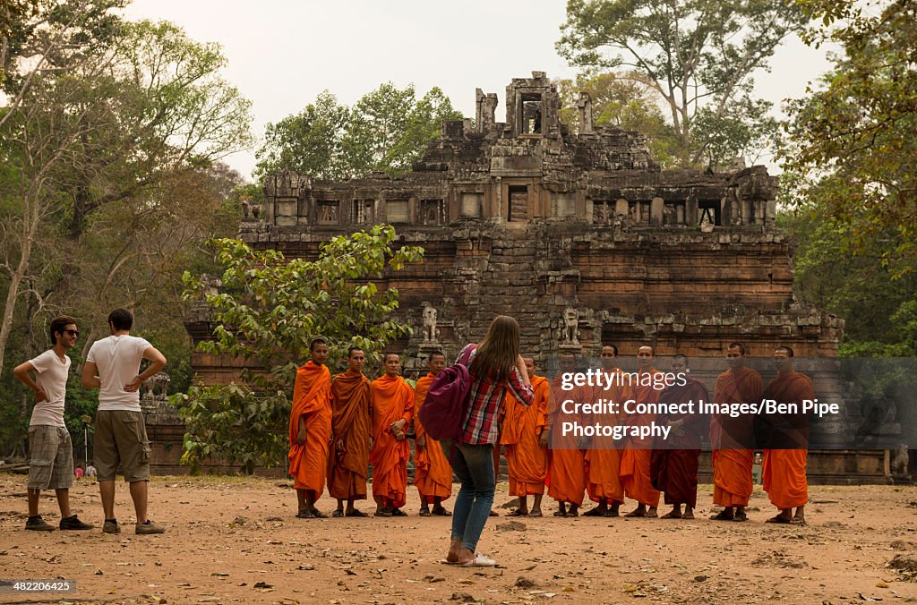 Tourist photographing monks, Phimeanakas Temple, Angkor Thom, Siem Reap, Cambodia