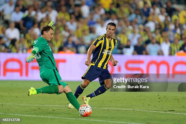 Robin van Persie of Fenerbahce is in action with Andriy Pyatov of Shaktar Donetsk during UEFA Champions League Third Qualifying Round 1st Leg match...