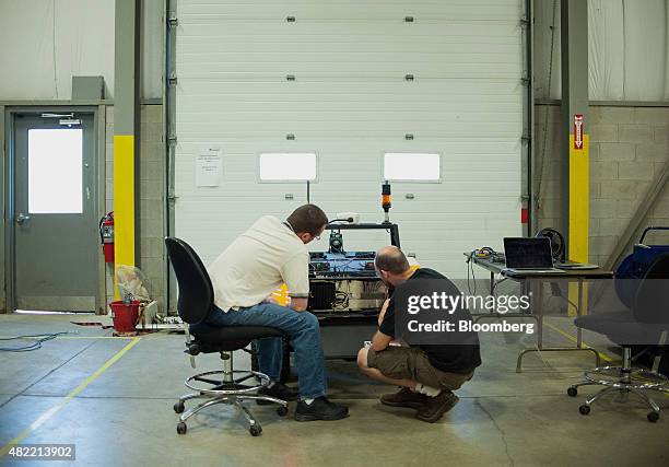 Engineers work on Grizzly, the company's largest robot, at the Clearpath Robotics Inc. Facility in Kitchener, Ontario, Canada, on Friday, July 24,...