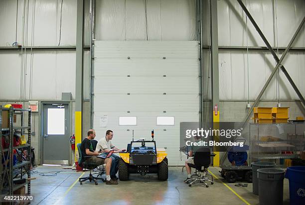 Engineers work on Grizzly, the company's largest robot, at the Clearpath Robotics Inc. Facility in Kitchener, Ontario, Canada, on Friday, July 24,...