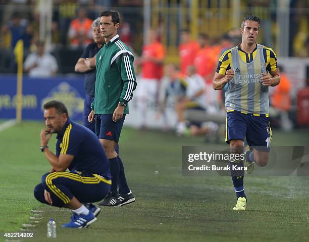 Robin van Persie of Fenerbahce runs near the pitch as Fenerbahce's coach Vítor Pereira watches the match during UEFA Champions League Third...