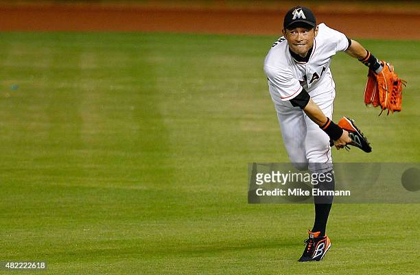 Ichiro Suzuki of the Miami Marlins makes a throw home during a game against the Washington Nationals at Marlins Park on July 28, 2015 in Miami,...