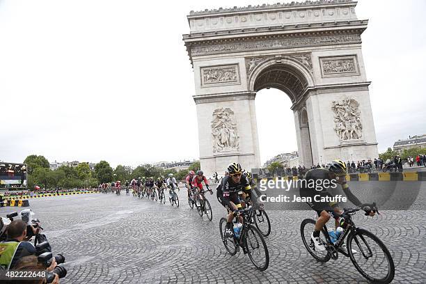 Luke Rowe of Great Britain and Team Sky and Geraint Thomas of Great Britain and Team Sky lead the pack around the Arc de Triomphe during stage twenty...