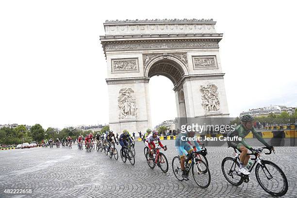 Angelo Tulik of France and Team Europcar, Michele Scarponi of Italy and Astana Pro Team lead the pack around the Arc de Triomphe during stage twenty...