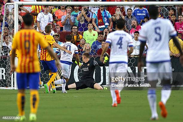 Eden Hazard of Chelsea scores on goalkeeper Marc Andre ter Stegen of Barcelona in the first half during the International Champions Cup North America...