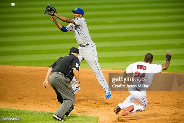 Second base umpire Eric Cooper watches as Michael Bourn of the Cleveland Indians is safe at second on a stolen base as second baseman Alcides Escobar...