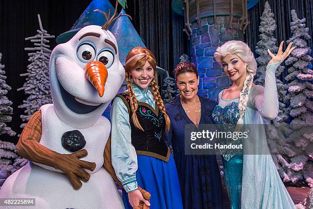 In this handout image provided by Disney Parks, Tony Award-winning actress and singer Idina Menzel poses on July 28, 2015 with Elsa, Anna and Olaf...