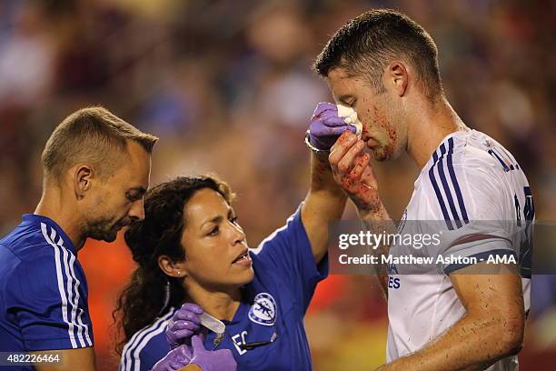 Chelsea first-team doctor Eva Carneiro attends to Gary Cahill of Chelsea who suffered a bloody nose following scoring the goal which tied the game...