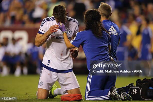 Chelsea first-team doctor Eva Carneiro attends to Gary Cahill of Chelsea who suffered a bloody nose following scoring the goal which tied the game...