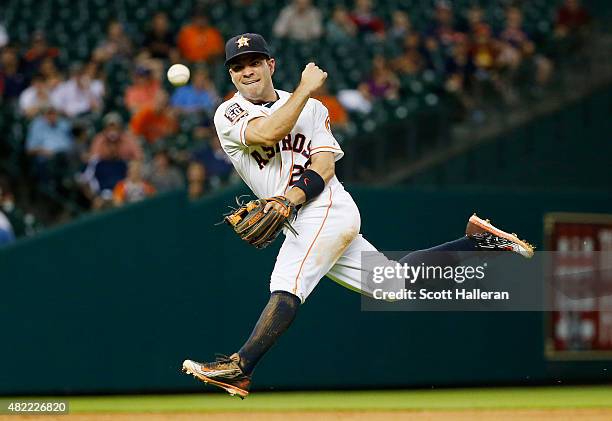 Jose Altuve of the Houston Astros throws to first base in the eighth inning of their game against the Los Angeles Angels of Anaheim at Minute Maid...