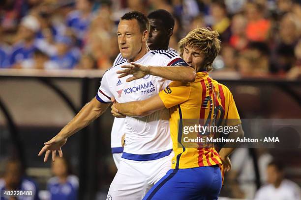 John Terry of Chelsea tangles with Sergi Samper of FC Barcelona during the International Champions Cup match between Barcelona and Chelsea at...