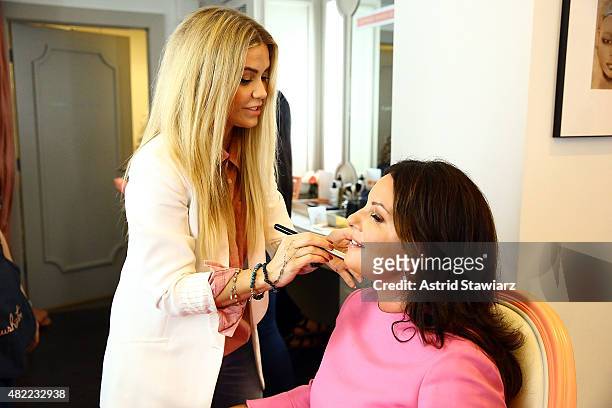 Blushington director of artistry Jessica Scantlin applies makeup to Susan Maron at the Blushington New York City Grand Opening Party at Le Parker...