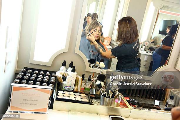 Model Natalie Suarez gets makeup applied at the Blushington New York City Grand Opening Party at Le Parker Meridien Underground on July 28, 2015 in...