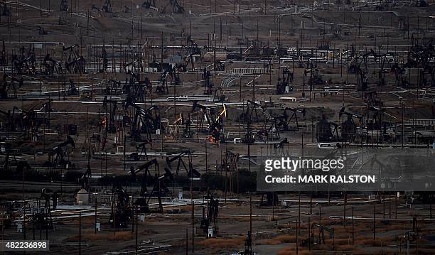 General view shows oil pumping jacks and drilling pads at the Kern River Oil Field where the principle operator is the Chevron Corporation in...