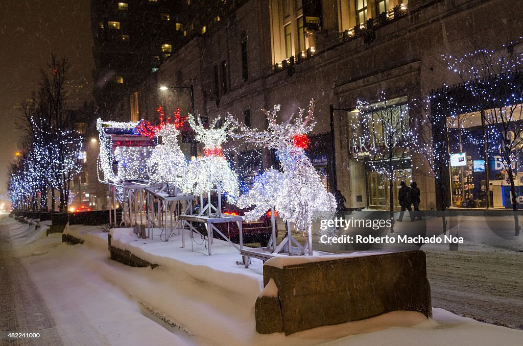 Covered of snow road, illuminated Christmas lights in street...