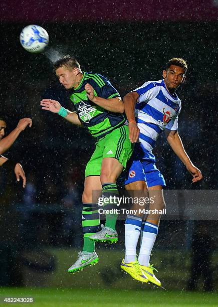 Franck Tabanou of Swansea City wins the ball in the air from Nick Blackman of Reading during the Pre Season Friendly match between Reading and...