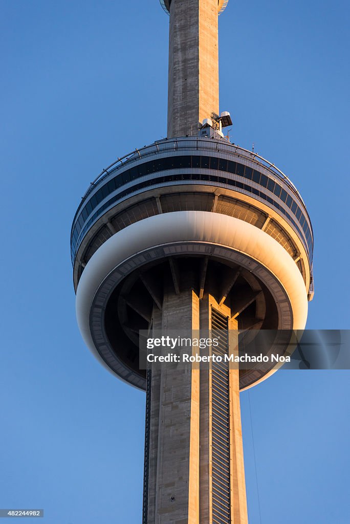 Close-up of CN Tower against clear blue sky at sunset. The...