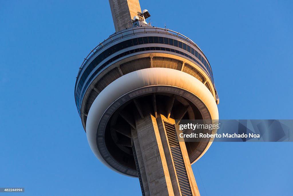 Close-up of CN Tower against blue sky at sunset. The CN...