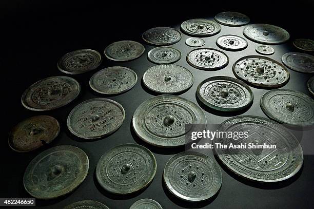 Unearthed copper mirrors, registered as national treasure, are arranged for the shooting on July 28, 2015 in Munakata, Fukuoka, Japan. The Council...