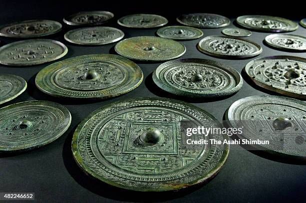 Unearthed copper mirrors, registered as national treasure, are arranged for the shooting on July 28, 2015 in Munakata, Fukuoka, Japan. The Council...