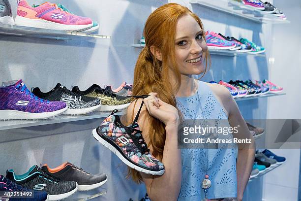 Barbara Meier poses with Skechers shoes during the first day of the GDS - Global Destination for Shoes & Accessories tradeshow on July 29, 2015 in...