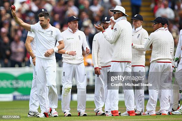 James Anderson of England raises the match ball after claiming the wicket of Mitchell Johnson his fifth wicket of the innings during day one of the...