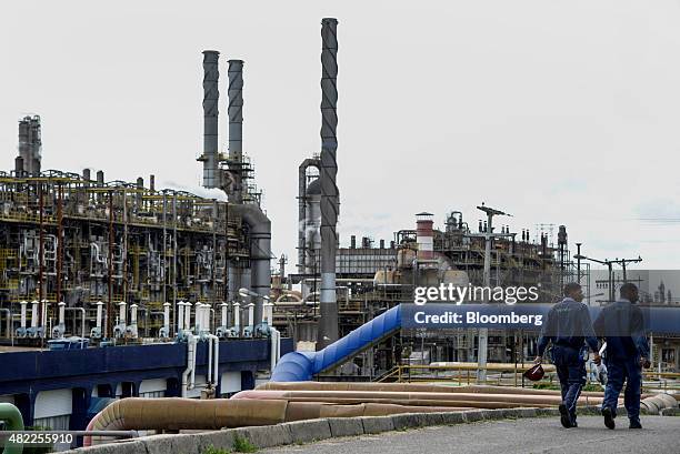Workers walk past the Braskem SA petrochemical plant in Camacari, Brazil, on Tuesday, July 28, 2015. Brazilian prosecutors claim that Braskem bought...