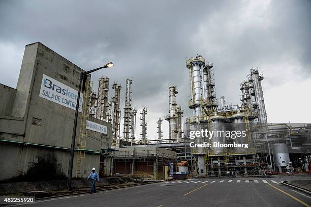 Worker walks past the Braskem SA petrochemical plant in Camacari, Brazil, on Tuesday, July 28, 2015. Brazilian prosecutors claim that Braskem bought...