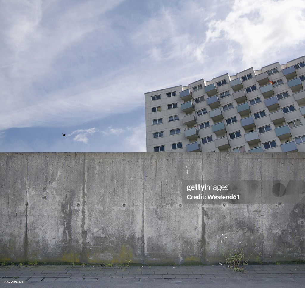 Building behind a concrete wall, composing