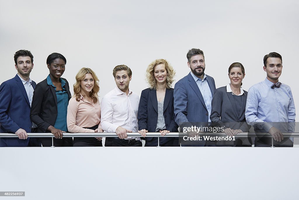 Germany, Neuss, Group of business people standing behind railing