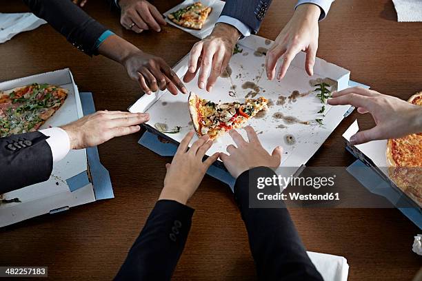 germnay, neuss, hands reaching for pizza - reaching high stock pictures, royalty-free photos & images