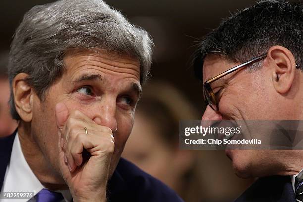 Secretary of State John Kerry and Treasury Secretary Jacob Lew talks during a break from testifying before the Senate Armed Services Committee about...