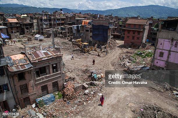Residents stand in a square where all houses were damaged or collapsed after the earthquake that hit Nepal on July 29, 2015 in Bhaktapur, Nepal....
