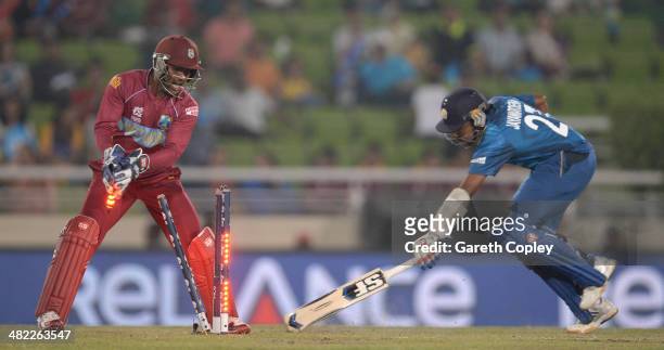 Denesh Ramdin of the West Indies runs out Mahela Jayawardena of Sri Lanka during the ICC World Twenty20 Bangladesh 2014 semi final between Sri Lanka...