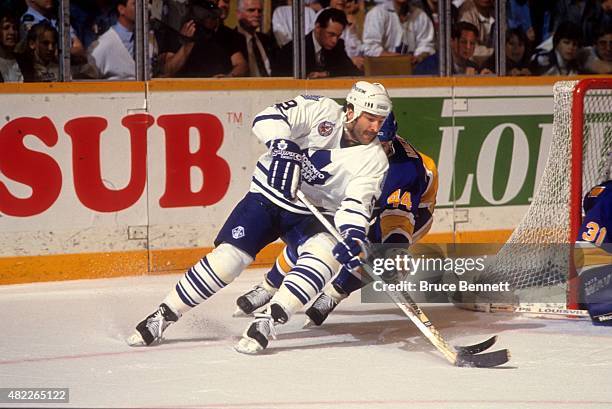 Glenn Anderson of the Toronto Maple Leafs goes for the wrap around as Bret Hedican of the St. Louis Blues defends circa 1993 at the Maple Leaf...