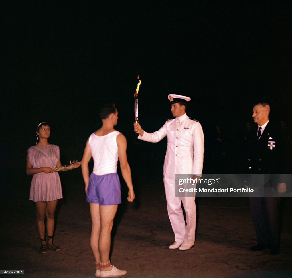 Constantine of Greece gives the Olympic torch to the Italian torchbearer