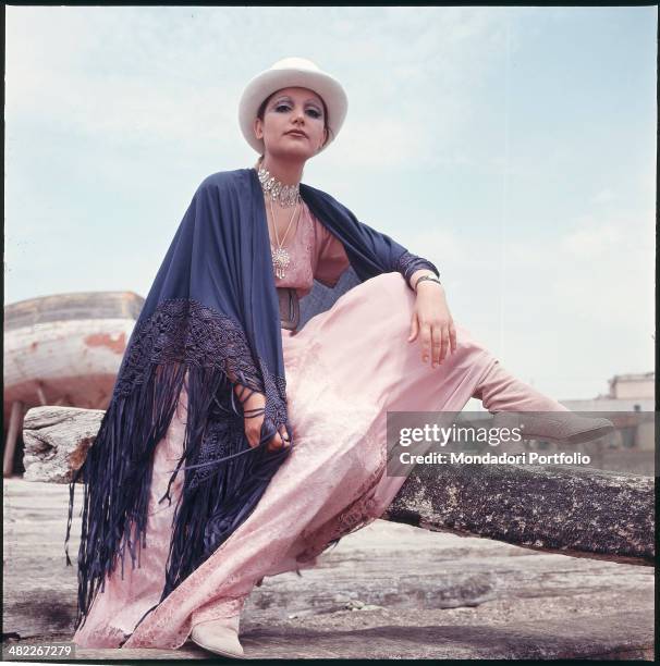 Italian singer Mia Martini wearing a shawl and a hat. 1971