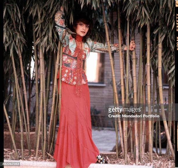 Italian singer Mia Martini posing next to some ditch reeds. 1973