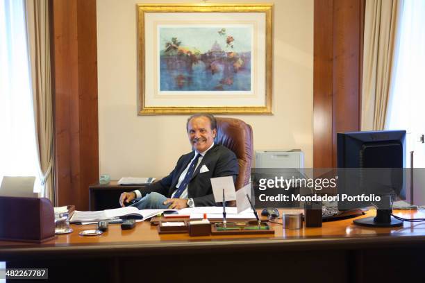 Mauro Masi, the italian executive chief of "Consap", sits smiling at his desk. July 15, 2011
