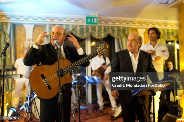 Italian actor and comedian Lino Banfi performs music accompanied by a band during his party at the hotel Parco dei Principi, where celebrated with...