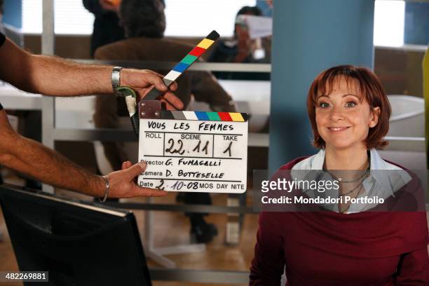 Comic actress Debora Villa poses next to a clapperboard during a photo shoot on the set of Vous les femmes in 2008 at Villa Rapazzini, Arcore , Italy.