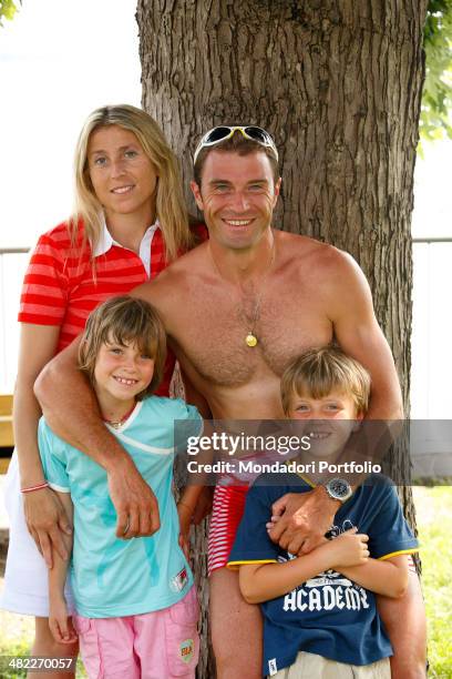 Italian sprint canoer Antonio Rossi poses together with his wife Lucia and their children Riccardo and Angelica near the shore of the lake of...