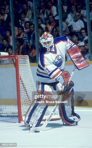 Goalie Grant Fuhr of the Edmonton Oilers looks to pass the puck during an 1987 Stanley Cup Finals game against the Philadelphia Flyers in May, 1987...